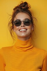 cheerful chick in black sunglasses on a yellow background