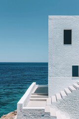 Architectural detail of white modern Mediterranean house over turquoise sea and blue sky background. Minimal architecture building detail in coastline by ocean or sea