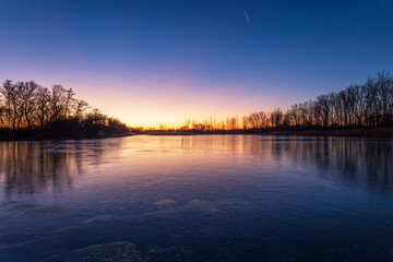 Evening landscape at sunset by the pond.