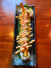 Prawn tempura roll at table.