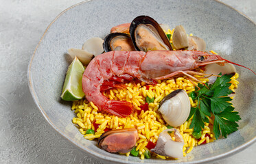 seafood paella, on a plate, traditional Spanish dish, top view, no people,
