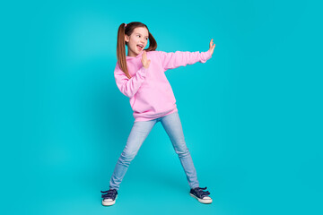 Full size photo of pretty little girl stretch hands stop gesture wear trendy pink outfit isolated on aquamarine color background