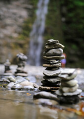 Zen balanced stones stacked against Eagle Cliff Falls.