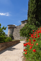 The historic Torre dei prigionieri tower looms within Brescia medieval castle walls, amidst a...