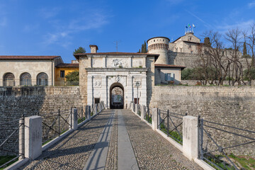 The main entrance to Brescia historical castle in Lombardy is adorned with a lion relief, leading...