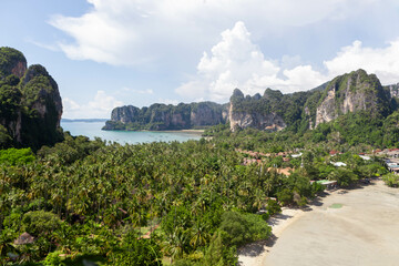 Railay beach. Krabi province. Thailand. Green limestone cliffs, jungles, palms, beaches and bay.