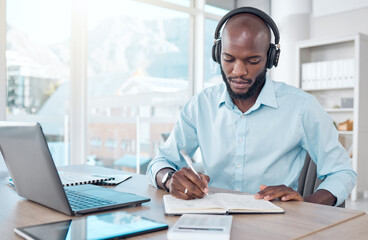 Headphones, writing and black businessman in office, workspace or professional space for work in...