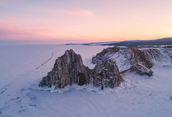 Aerial shot of a Shamanka rock on Olkhon island at sunset. Winter landscape. Popular touristic...
