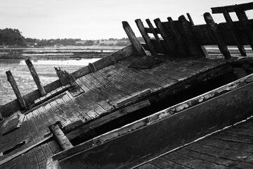 A wreck of a wooden boat. Black and white view of the deck of an abandoned ship.