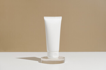 White mockup jar of cream or lotion on a pedestal on a beige background. The concept of natural daily care cosmetics.