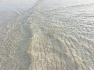 Transparent sea water, natural sea surface background, sea water, sand bottom