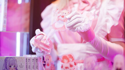 Headless pink maid cosplay showing different anime maid figures on art stand