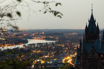 Drachenburg Castle in the Siebengebirge, Germany. On the horizon the Cologne Cathedral in the...