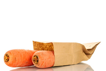 Several sweet carrots with paper bag, macro, isolated on white background.