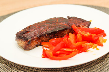 Prepared striploin steak with stewed pepper