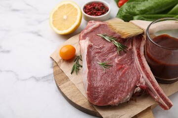 Raw meat, rosemary, marinade and products on white marble table, closeup. Space for text