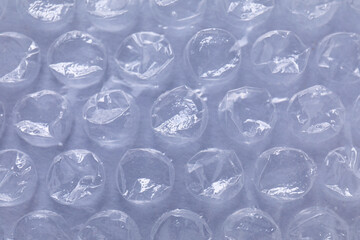 Transparent bubble wrap on gray background, closeup