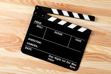 One clapperboard on wooden table, top view