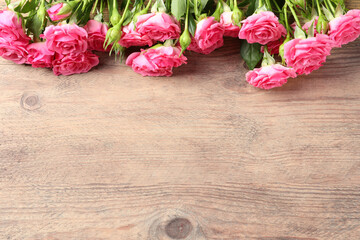 Happy Mother's Day. Beautiful flowers on wooden table, above view. Space for text