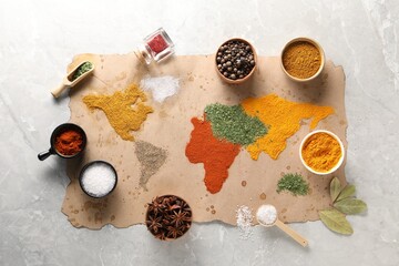 World map of different spices and products on light grey marble table, top view