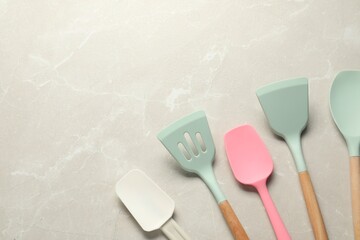 Different spatulas on light marble table, flat lay. Space for text - obrazy, fototapety, plakaty