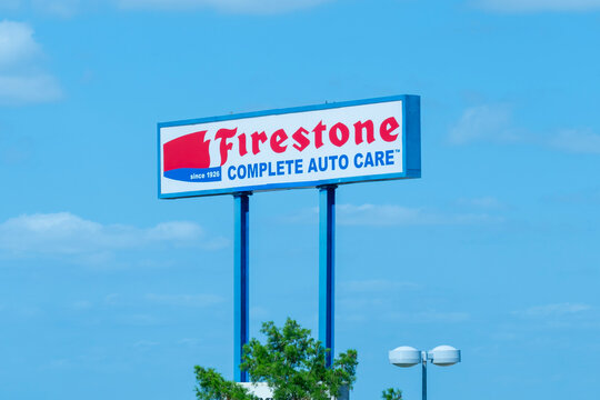 

Houston, TX, USA - April 14, 2024: Firestone Complete Auto Care pole sign with blue sky in the background. 
