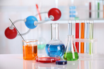 Different glassware and molecule model in laboratory