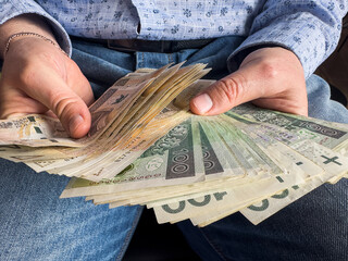 close up man holds a large stack 100 200 of polish money. Pln zloty zl