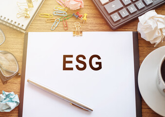 ESG Concept Highlighted on Paper With Office Supplies Around