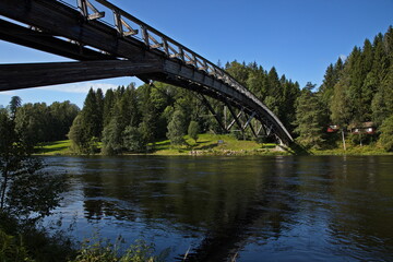 Footbridge over the river Lagen in Kjaerra Fossepark in Norway, Europe
