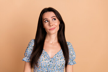 Photo of minded lovely woman dressed blue trendy flowers print clothes look empty space isolated on...