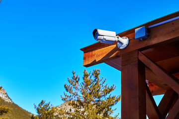 video surveillance camera mounted on a wooden canopy