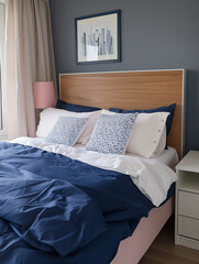 Cozy bedroom with wooden headboard, blue and white bedding and modern artwork on wall