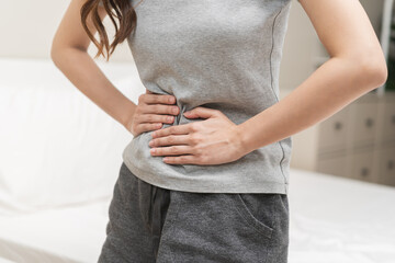 Flatulence ulcer, asian young woman, girl hands in belly, stomach pain from food poisoning,...