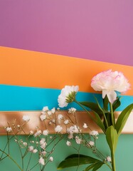 fleurs dont oeillets posés sur une succession de pages de couleurs en ia