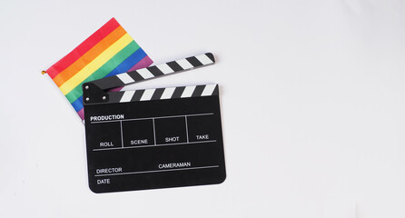 Clapperboard and Rainbow pride flag on white ackground.