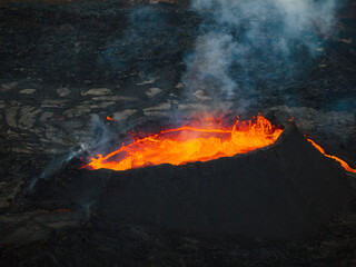 Fantastic directly above close-up shot of boiling glowing lava inside a volcano crater, aerial...