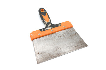 Detail of a masonry tool, it is a wide finishing spatula. It has a steel blade and an orange and...