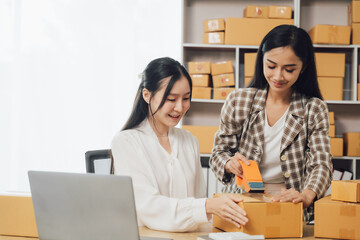 Starting small businesses SME owners female entrepreneurs Use a laptop or notebook to receive and...