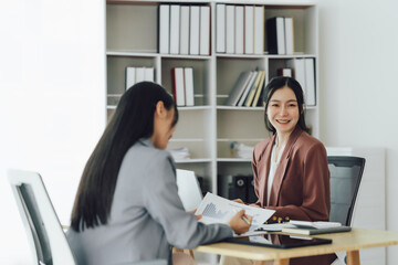 Entrepreneur Asian businesswoman discussing new business project in tablet in modern Meeting In Modern Office, Asian business casual concept.