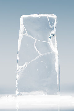 Crystal clear frosty textured natural ice block with cracks on shining mirroring glossy surface.