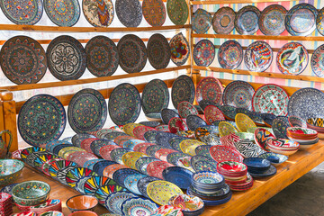 An assortment of handmade Uzbek plates and bowls - obrazy, fototapety, plakaty