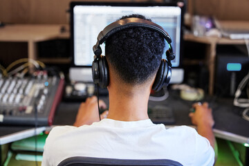 DJ, computer and man in recording studio for music producer with tech and headphones. Sound...