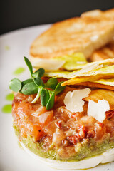 delicious fresh salmon tartar on a white plate