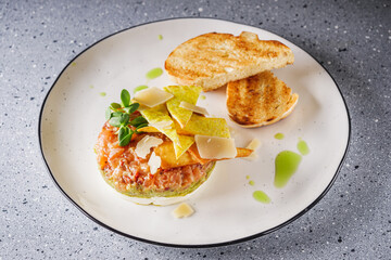 delicious fresh salmon tartar on a white plate