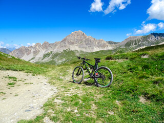 Mountain bike on scenic trail with view of Rocca La Meja near rifugio della Gardetta on Italy...