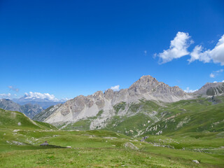 Fototapeta na wymiar Scenic mtb trail with view of Rocca La Meja near rifugio della Gardetta on the Italy French border in Maira valley in the Cottian Alps, Piedmont, Italy, Europe. Hiking on sunny summer day in mountains