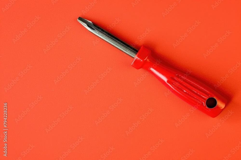 Poster a red screwdriver laying on an orange surface. suitable for diy and construction concepts