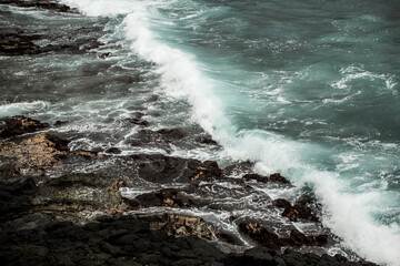 waves crashing on lava rock