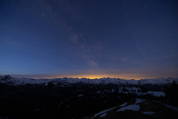 The summer Milky Way rises over the mountains in the alps in Switzerland. Centre of the Galaxy....